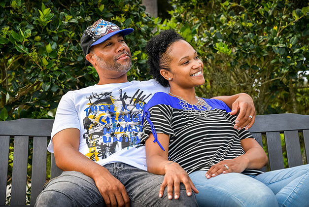 Personal happiness and finding true love - Happy African-American couple sitting on a park bench